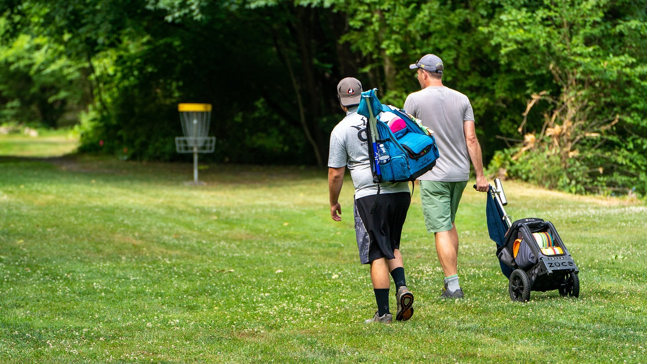 Disc golfers carry their discs in bags on a course